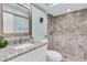 Bathroom featuring a granite vanity, brushed nickel plumbing fixtures, and a tiled walk-in shower at 4055 Floramar Ter, New Port Richey, FL 34652