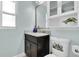 Cozy bathroom with granite vanity, patterned toilet, and built-in shelving at 4055 Floramar Ter, New Port Richey, FL 34652