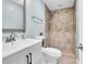 A beautifully updated bathroom with granite countertops, tiled shower, and brushed nickel plumbing fixtures at 4055 Floramar Ter, New Port Richey, FL 34652