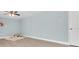 A minimalist bedroom with laminate floors, light blue walls, a ceiling fan, and a unique arched wall decor at 4055 Floramar Ter, New Port Richey, FL 34652