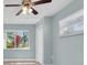 Light-filled bedroom featuring a ceiling fan, window with blinds, and a closet at 4055 Floramar Ter, New Port Richey, FL 34652