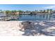 Outdoor fire pit on brick paved patio with canal views at 4055 Floramar Ter, New Port Richey, FL 34652