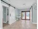 Light-filled foyer with tiled floor, sliding barn doors, and front door at 4055 Floramar Ter, New Port Richey, FL 34652