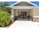 Inviting front porch with decorative columns and double entry doors at 4055 Floramar Ter, New Port Richey, FL 34652