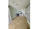 Long hallway with tiled floor, sliding barn doors, and view to front at 4055 Floramar Ter, New Port Richey, FL 34652