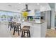 Island kitchen with granite countertop, stainless appliances, bar seating, and waterfront views at 4055 Floramar Ter, New Port Richey, FL 34652