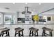 Island kitchen with granite countertop, stainless hood, bar seating, and recessed lighting at 4055 Floramar Ter, New Port Richey, FL 34652