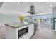 Island kitchen with granite countertop, stainless appliances, bar seating, and bright lighting at 4055 Floramar Ter, New Port Richey, FL 34652