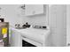 Bright laundry room with modern washer and dryer and overhead cabinets at 4055 Floramar Ter, New Port Richey, FL 34652