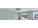 Bright living area with views, fan, and laminated floors at 4055 Floramar Ter, New Port Richey, FL 34652