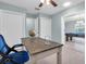 Bright office with built-in storage, open layout to game room with pool table, and neutral color scheme at 4055 Floramar Ter, New Port Richey, FL 34652
