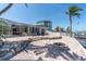 Spacious patio featuring a fire pit, beautiful landscaping, and stunning waterfront views, perfect for outdoor entertaining at 4055 Floramar Ter, New Port Richey, FL 34652