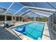 Enclosed pool with clear roof and a seating area, offering a private oasis at 4055 Floramar Ter, New Port Richey, FL 34652