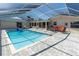 Enclosed pool with clear roof and paved deck with outdoor seating at 4055 Floramar Ter, New Port Richey, FL 34652