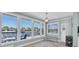 The sun room features a view of the water, tile floors, a modern light fixture, and light blue walls at 4055 Floramar Ter, New Port Richey, FL 34652