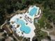 Resort-style community pool with multiple pools, splash pad and beautiful landscaping at 4093 Epic Cv, Land O Lakes, FL 34638