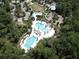 Community amenities featuring a playground, resort-style pool, and lush landscaping at 4093 Epic Cv, Land O Lakes, FL 34638