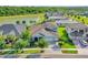 Aerial view of home showcasing lake view, three-car garage, and luxurious neighborhood at 4093 Epic Cv, Land O Lakes, FL 34638