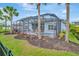 This backyard boasts a screened lanai, pool, patio with outdoor kitchen, and manicured landscaping at 4093 Epic Cv, Land O Lakes, FL 34638