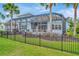 The backyard features a pool in screened lanai, an outdoor kitchen, and lush landscaping at 4093 Epic Cv, Land O Lakes, FL 34638