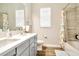 Modern bathroom featuring a double vanity, tiled bathtub, and a clean, contemporary design at 4093 Epic Cv, Land O Lakes, FL 34638