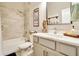 Modern bathroom featuring a marble countertop, bathtub-shower combo, and tasteful decor, providing a serene bathing experience at 4093 Epic Cv, Land O Lakes, FL 34638