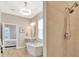 Well-lit bathroom featuring a modern standalone tub and tiled shower for a luxurious bathing experience at 4093 Epic Cv, Land O Lakes, FL 34638