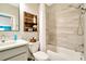 Well-appointed bathroom featuring modern fixtures, a shower-tub combination, and stylish shelving, offering a refreshing space at 4093 Epic Cv, Land O Lakes, FL 34638