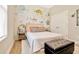 Charming bedroom featuring a queen-size bed, unique wallpaper, and stylish decor, creating a cozy and inviting space at 4093 Epic Cv, Land O Lakes, FL 34638