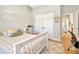 Cozy bedroom with a twin bed, white trim, and a view to the ensuite bathroom at 4093 Epic Cv, Land O Lakes, FL 34638