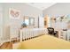 Sunlit bedroom with a twin bed, desk, and dresser, offering a comfortable and functional layout at 4093 Epic Cv, Land O Lakes, FL 34638
