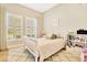 Bright bedroom with a cozy rug and a twin bed, featuring plenty of natural light at 4093 Epic Cv, Land O Lakes, FL 34638