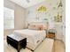 Bright bedroom with a comfortable queen bed, distinctive wallpaper, and elegant furnishings for a relaxing retreat at 4093 Epic Cv, Land O Lakes, FL 34638