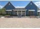 Front of the community clubhouse featuring double doors and two benches at 4093 Epic Cv, Land O Lakes, FL 34638