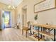Inviting foyer with a view to the porch featuring natural light, wood floors, and stylish decor at 4093 Epic Cv, Land O Lakes, FL 34638