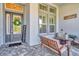 Inviting front porch with seating area, lanterns, and a welcome sign at 4093 Epic Cv, Land O Lakes, FL 34638