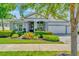 Charming home with lush landscaping, stone accents, and a welcoming front porch at 4093 Epic Cv, Land O Lakes, FL 34638