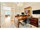 Spacious home office showcasing a desk, wood flooring and view into the living room at 4093 Epic Cv, Land O Lakes, FL 34638