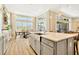 Bright kitchen with center island, modern lighting, stainless steel sink and expansive windows overlooking the backyard at 4093 Epic Cv, Land O Lakes, FL 34638