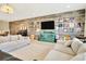 Inviting living room with comfortable sofas, media center, and vinyl record art providing a cozy entertainment space at 4093 Epic Cv, Land O Lakes, FL 34638