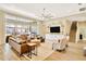 Open-concept living room with a large sofa, media center, and sliding glass doors leading to the backyard pool at 4093 Epic Cv, Land O Lakes, FL 34638