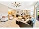 Bright, open living space featuring hardwood floors, neutral paint colors, and a modern ceiling fan at 4093 Epic Cv, Land O Lakes, FL 34638