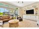 Comfortable living room featuring a large sofa, built-in media center, and access to an outdoor entertainment area at 4093 Epic Cv, Land O Lakes, FL 34638