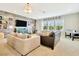 Bright and airy living room featuring ample seating, stylish decor, and large windows offering serene views of the neighborhood at 4093 Epic Cv, Land O Lakes, FL 34638