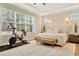 Bright main bedroom featuring a large window and seating for exercising at 4093 Epic Cv, Land O Lakes, FL 34638