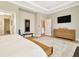 Cozy main bedroom featuring a TV, dresser and multiple entrances to bathrooms at 4093 Epic Cv, Land O Lakes, FL 34638