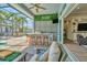 Outdoor kitchen with a bar and seating in a screened lanai at 4093 Epic Cv, Land O Lakes, FL 34638