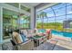 Screened-in patio with comfortable seating overlooking the pool at 4093 Epic Cv, Land O Lakes, FL 34638