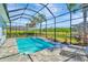 Backyard with screened in pool and landscaping at 4093 Epic Cv, Land O Lakes, FL 34638