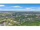 Aerial view of community with surrounding mature trees at 413 Somerset Ln, Palm Harbor, FL 34684